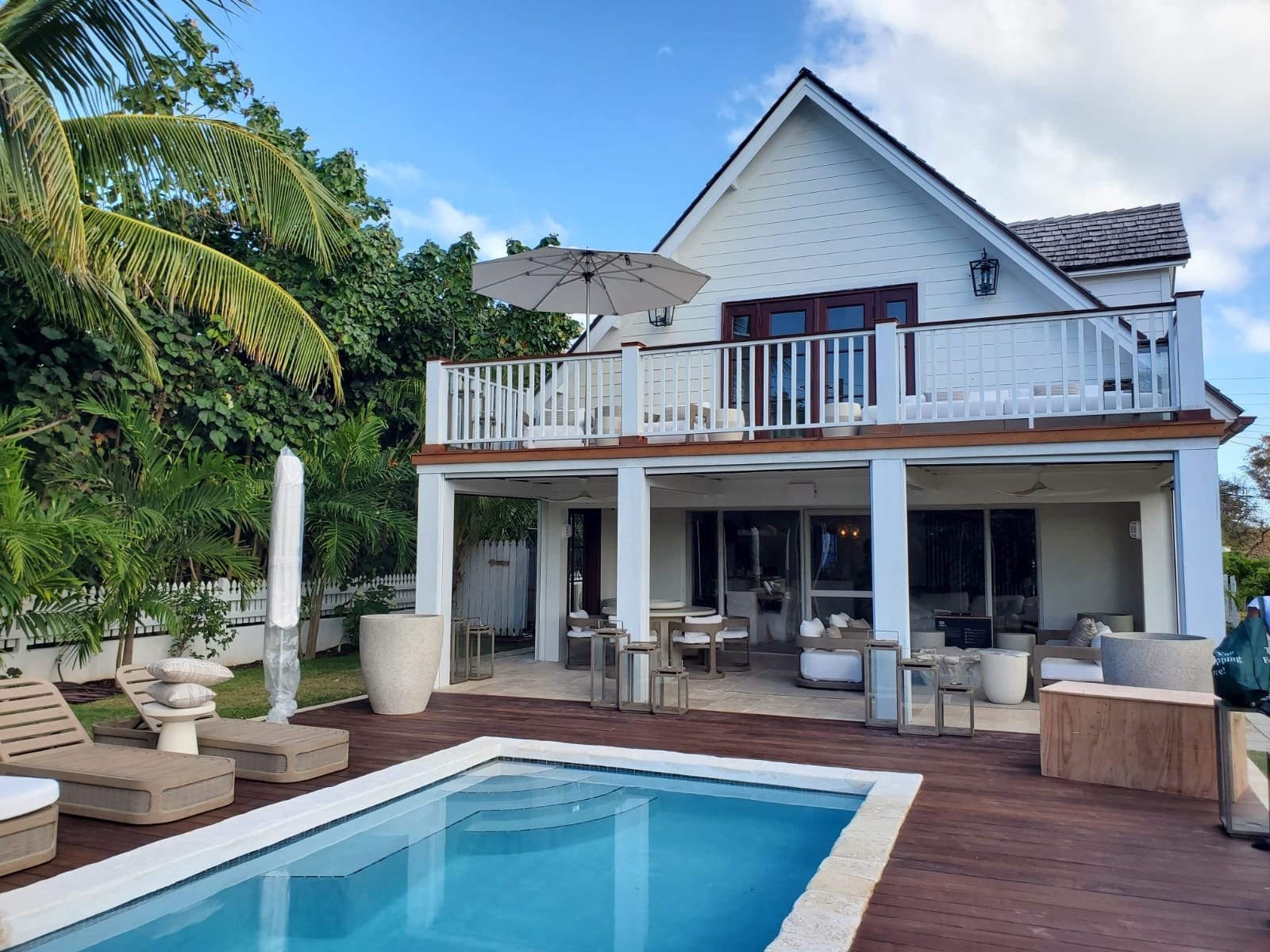 Two storey home built by Anderson Carpentry and Construction, with a covered terrace, upper balcony and pool set into a hardwood deck.