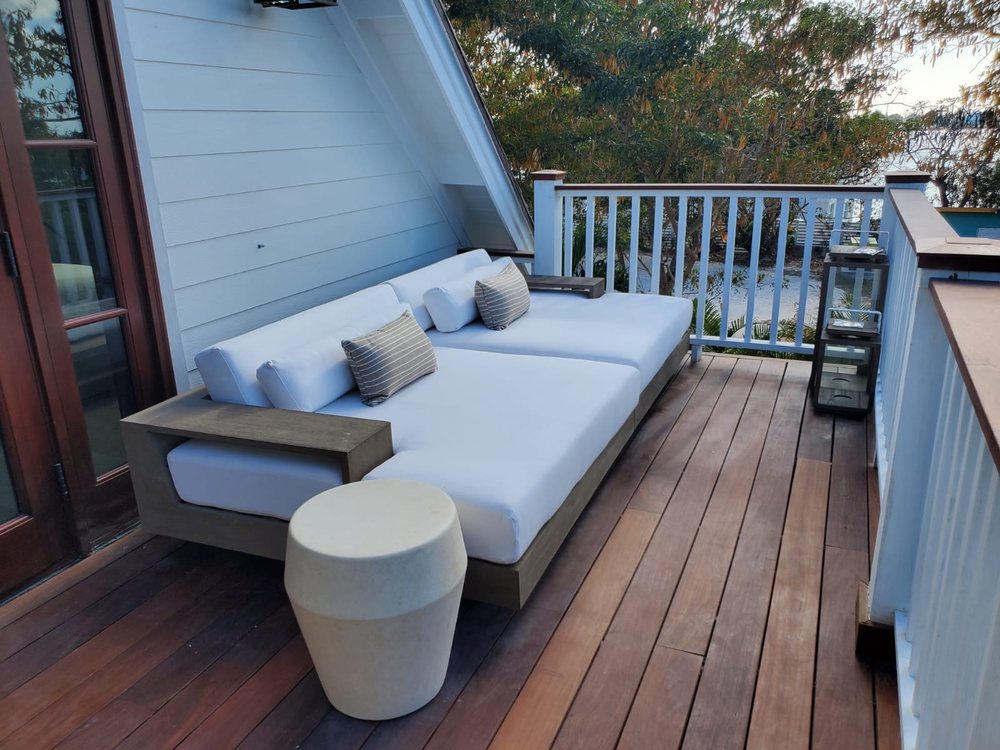 Upper deck seating area in hardwood overlooking the water.