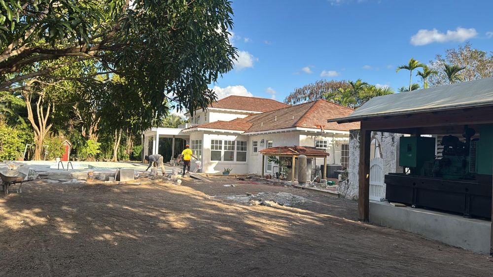 Crew working across the rear grounds during the build.