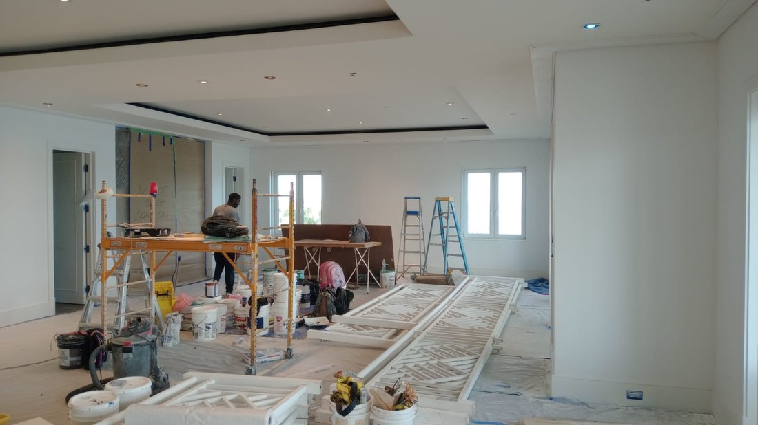 Chippendale railing panels laid out and being painted inside the house during the fit out.