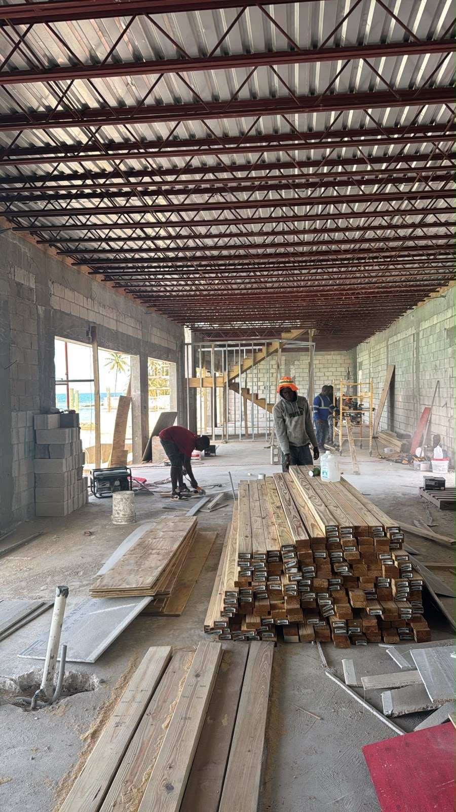 Steel bar joists spanning the ground floor with the crew setting out timber below.