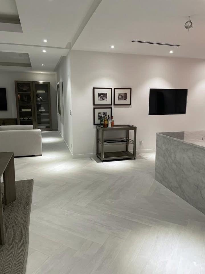 Herringbone stone flooring running through to a marble waterfall island.