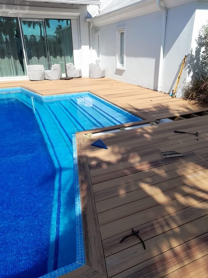 Lap pool with mosaic tiled lane lines set into a hardwood deck.
