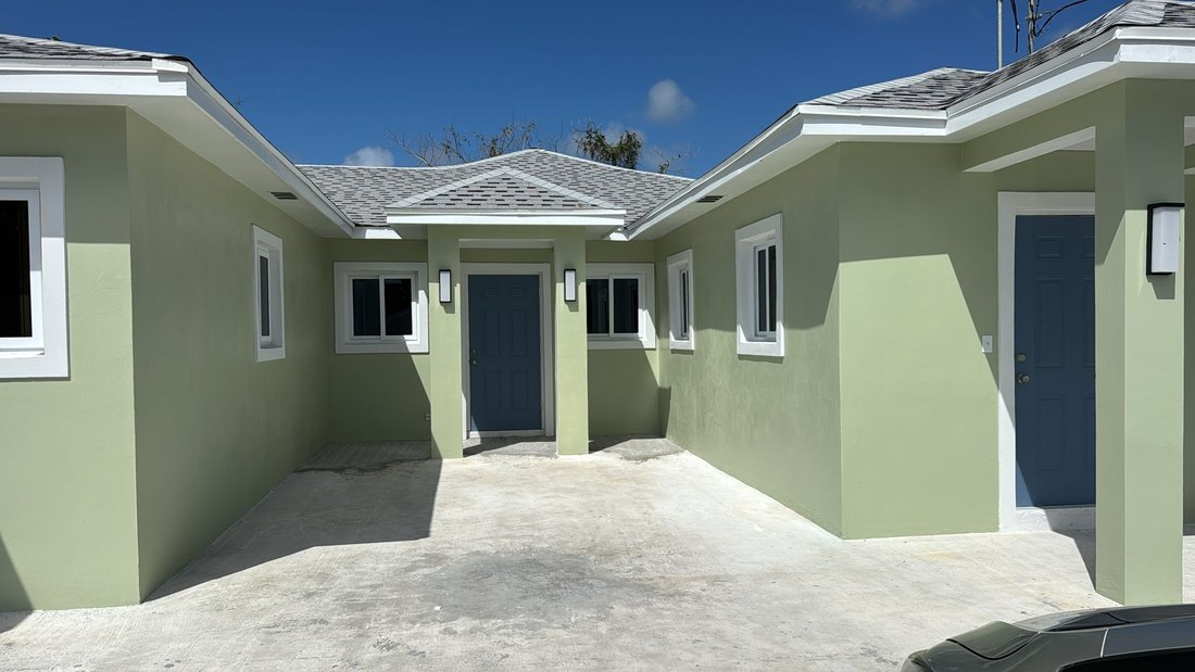 Courtyard between two units with paved parking and covered entries.