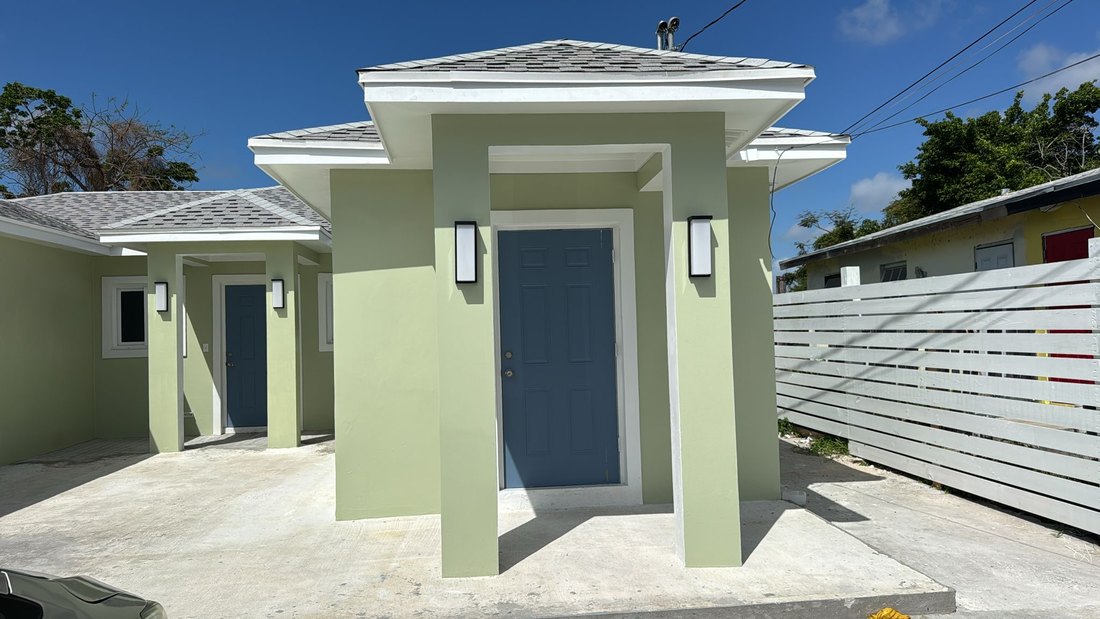 Close view of an entrance portico with wall lights either side of the door.